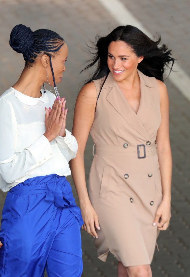  Meghan seemed cheery as she left the university and chatted with academics