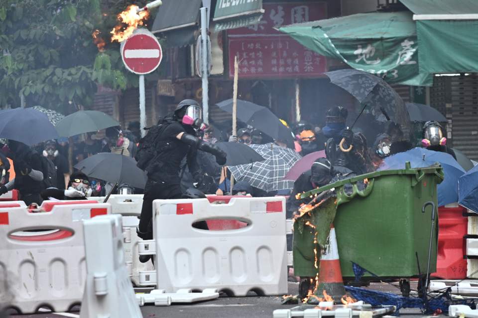  A protester throws a Molotov cocktail after police fired tear gear during a protest in Tsuen Wan