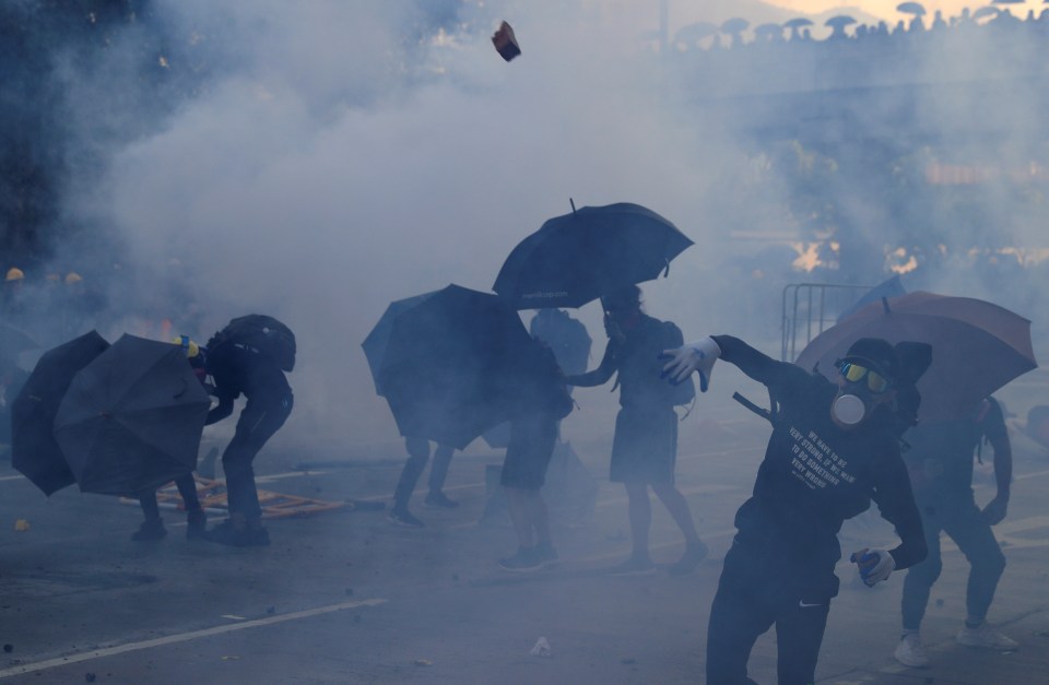  An anti-government protester throws an object during a protest