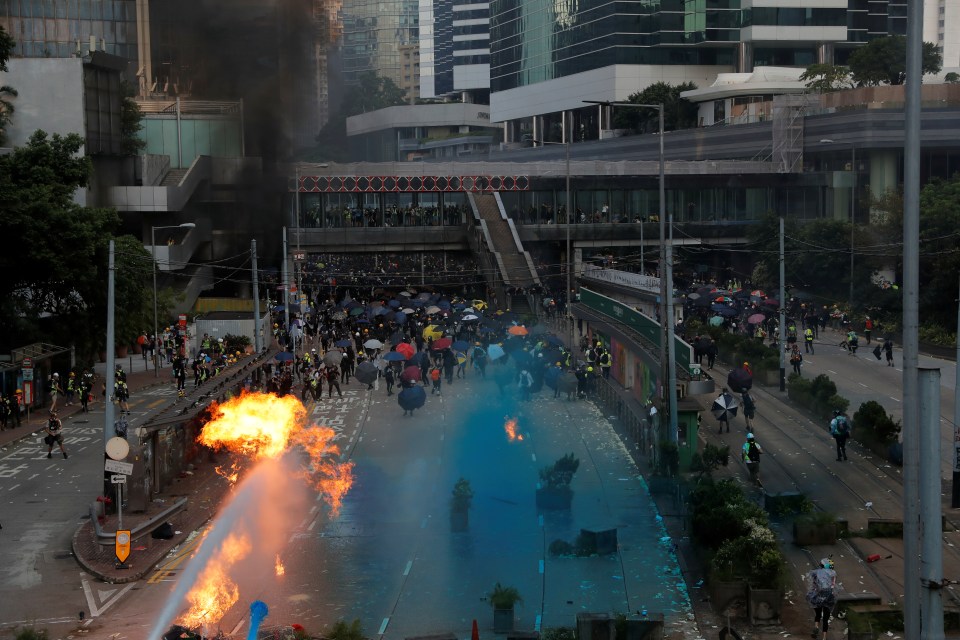  Riot police spray blue-coloured water during a protest on China's National Day in Hong Kong