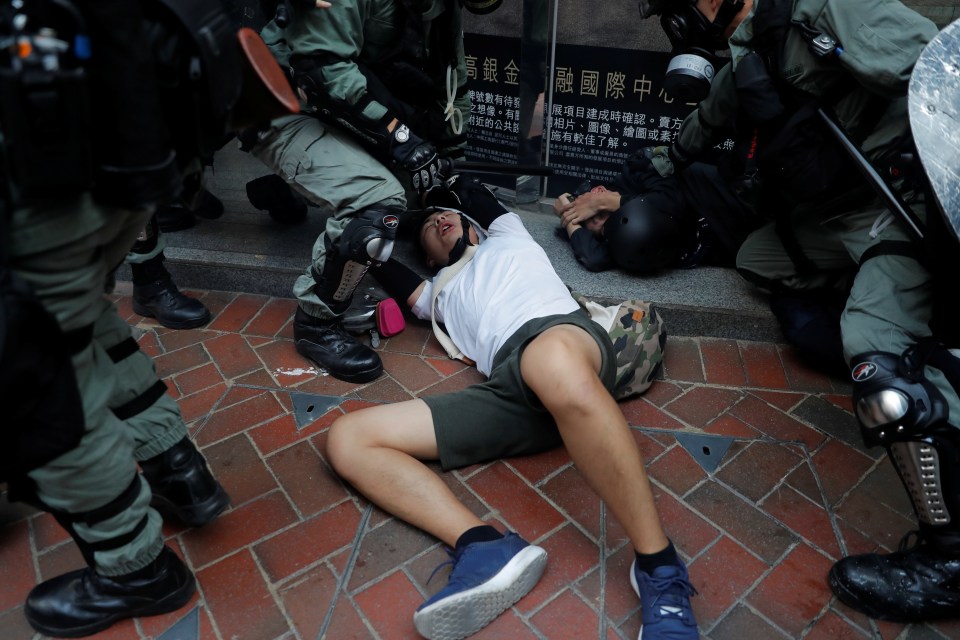  Police detain an anti-government protester