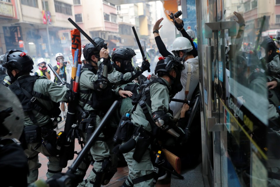  Riot police charge at anti-government protesters during a demonstration at Wan Chai district