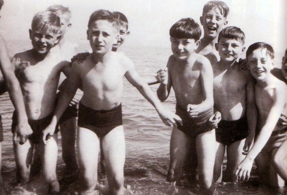  Peter Sissons (left) puts his left arm on John Lennon (centre left) who is standing next to Jimmy Tarbuck (centre right) and Brian Labone (top right) during a school trip to the Isle of Man in 1951