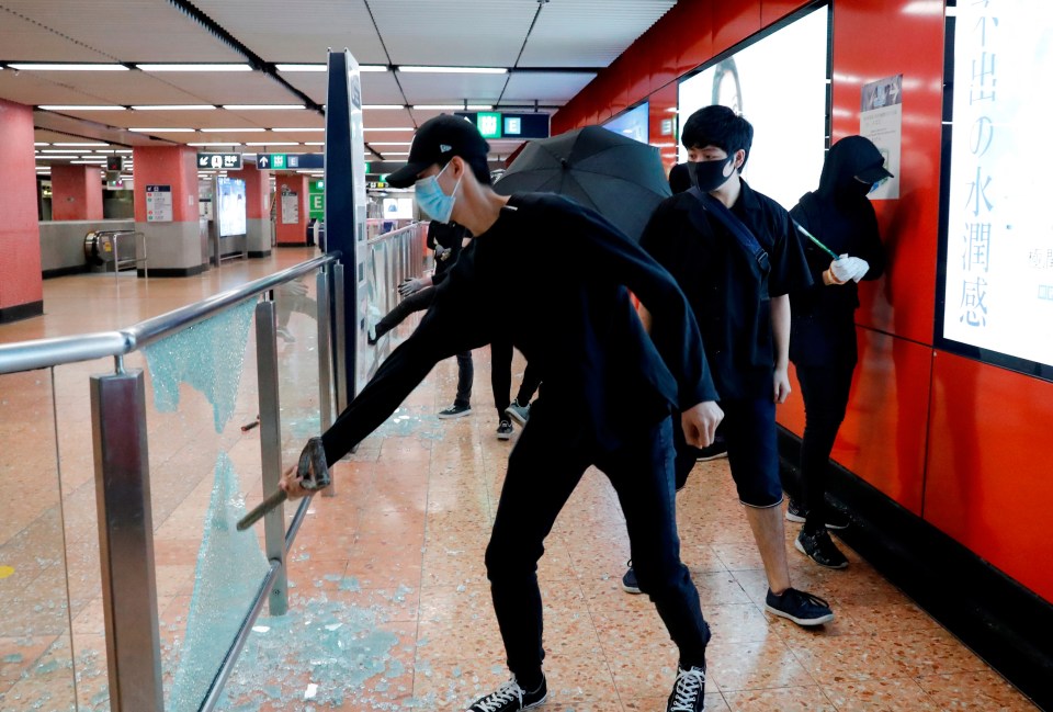  Protesters wearing masks smash Mong Kok Mass Transit Railway (MTR) station during a demonstration