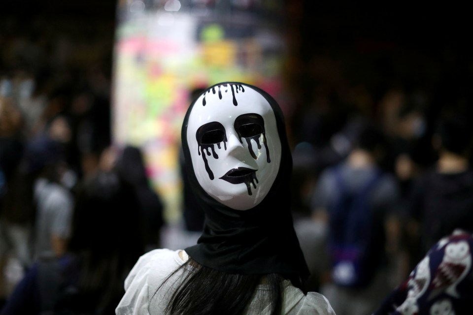  An anti-government protester wears a mask during a demonstration in Wong Tai Sin district, in Hong Kong