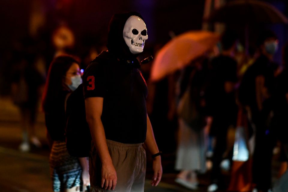  A protester wearing a skull mask is seen during a rally against an anti-mask law meant to deter anti-government protesters in Admiralty, Hong Kong