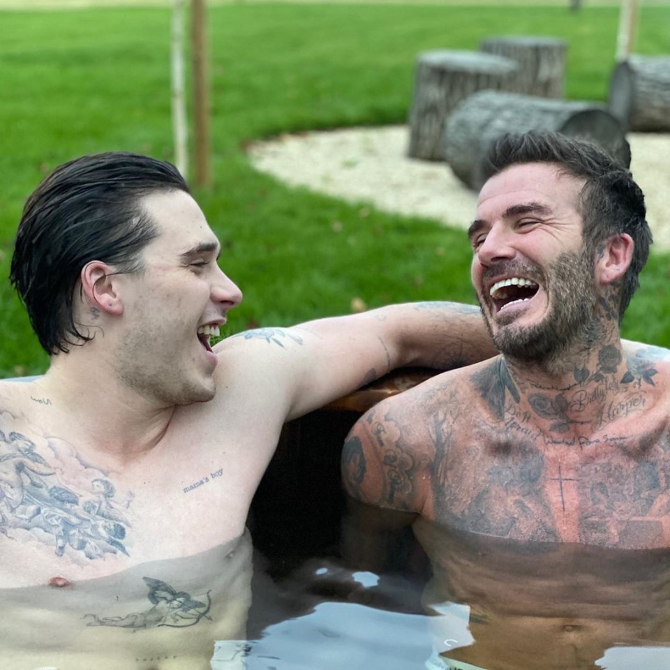  Brooklyn Beckham and his famous dad David revealed their tattooed bodies in an outdoor ice bath