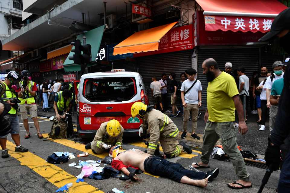  The cabbie is treated after being beaten unconscious by demonstrators