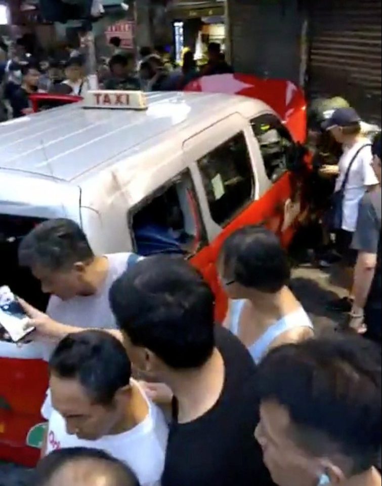  The taxi slammed into a shop before the driver was dragged out and beaten