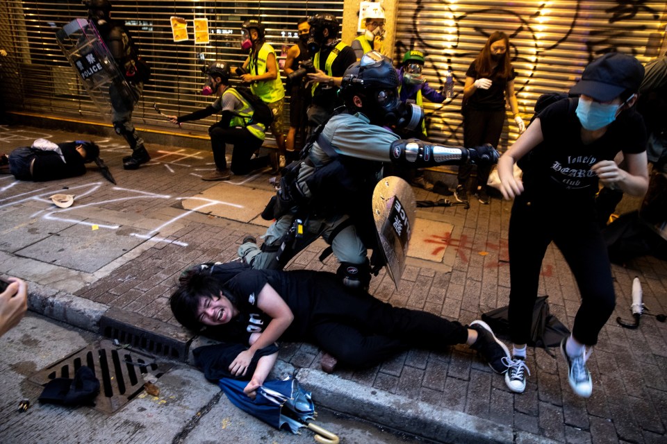  Riot officers make arrests at the protests in Hong Kong yesterday