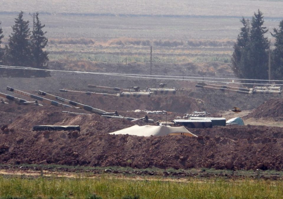  Turkish forces artillery pieces are seen on their new positions near the border with Syria in Sanliurfa province