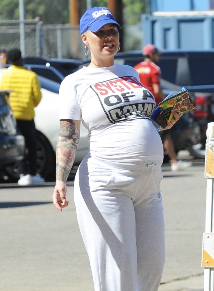  Pregnant Amber Rose showed off her huge baby bump as she cheered on son Sebastian's baseball game in LA