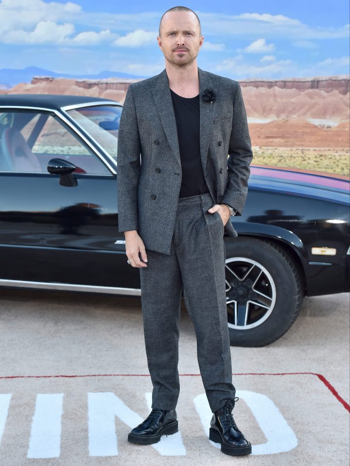  Aaron, who plays Jesse, cut a sharp figure in a grey suit and black T-Shirt