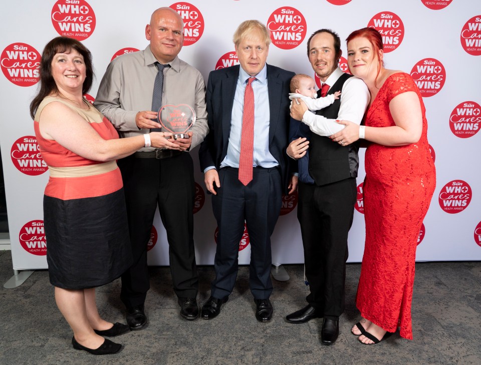  Mr Johnson stands alongside winners Nick Evans and Ruth Lowe, left, who were nominated by Sarah and Mike Clifford after saving their baby Logan