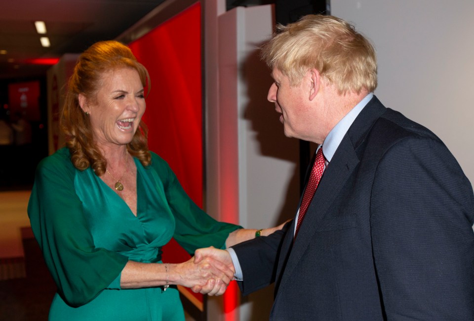  Mr Johnson shakes hands with the Duchess of York