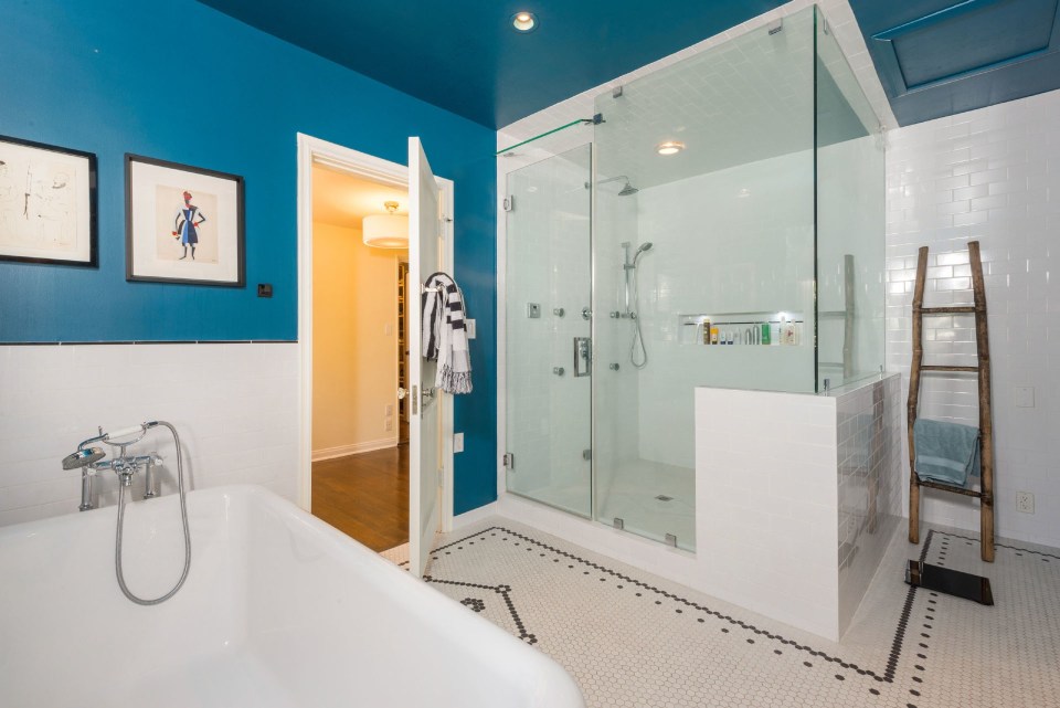  One of the bathrooms features a self-contained wet room