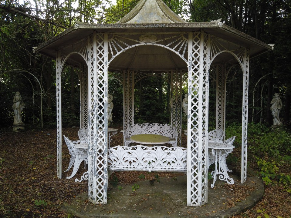  Decaying statues stand among the over-grown garden