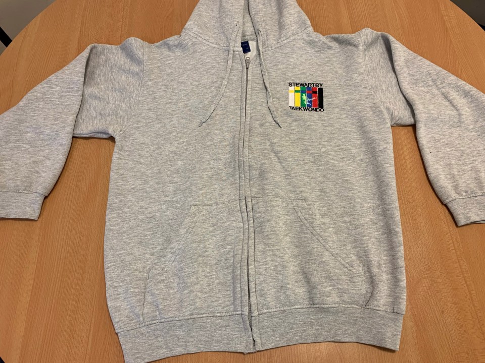  The front of the grey hoodie has a distinctive logo on it