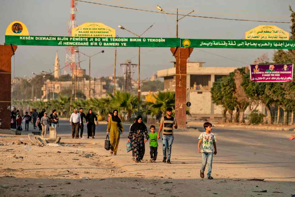  Civilians flee during the Turkish bombardment of Syria's northeast in the Hasakeh province, October 9