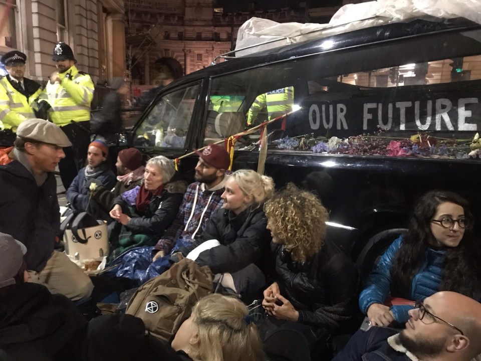  The luvvie sat in front of a hearse and coffin bearing the words: 'Our future'