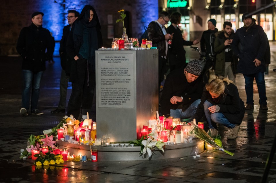 People came to light candles and lay flowers at a market place close to the scene