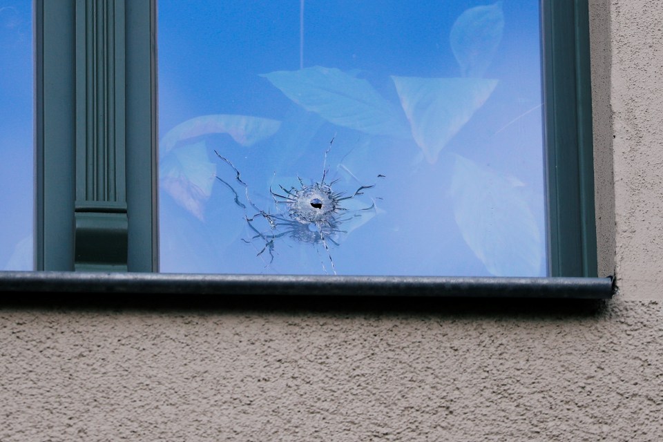 A bullet hole in a window near to the synagogue