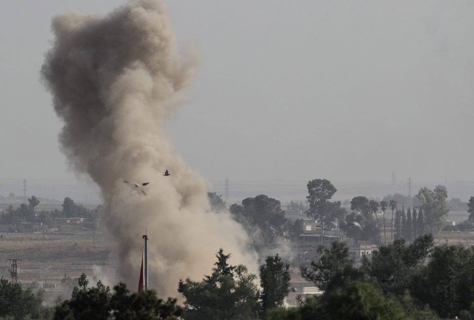  Smoke rises over the Syrian town of Ras al-Ain, as seen from the Turkish border town