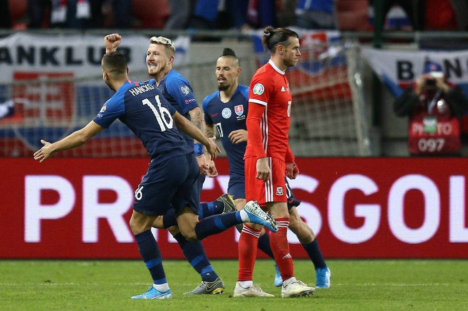  Gareth Bale is dejected as Juraj Kucka enjoys his Slovakie equaliser