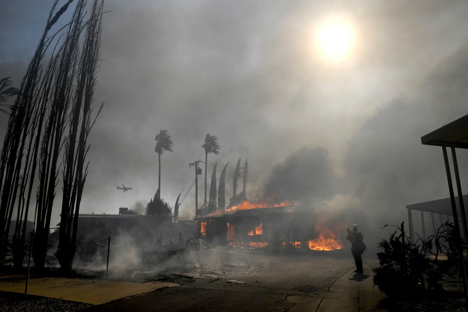 One burning building among the devastation of the fires in California, which officials say have been fuelled by hot and gusty winds