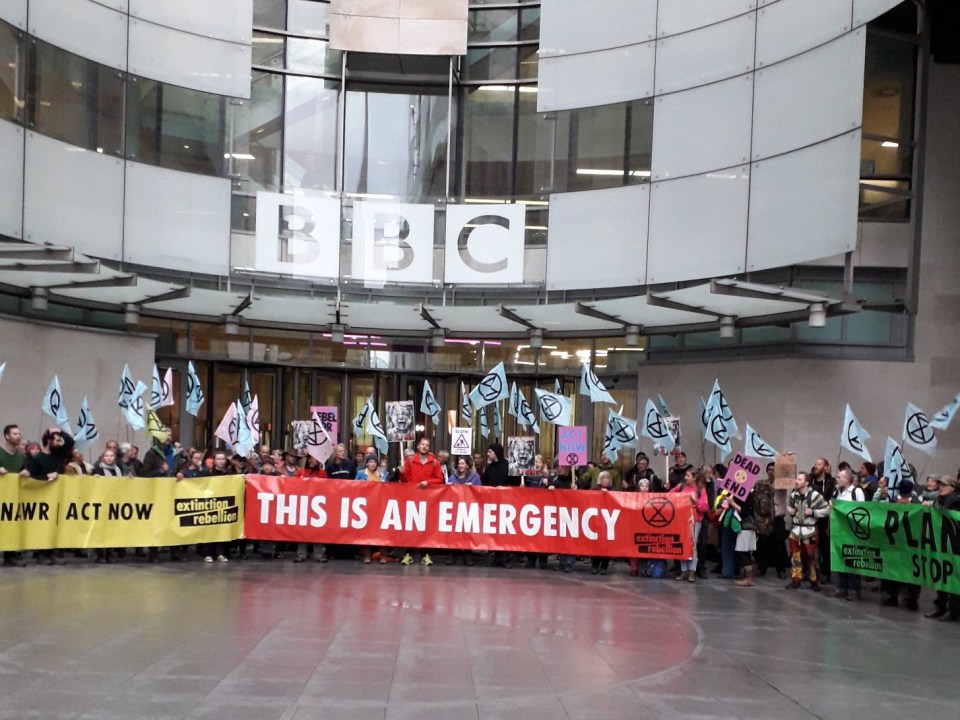  The group formed a ring around the BBC entrance - waving flags and holding banners