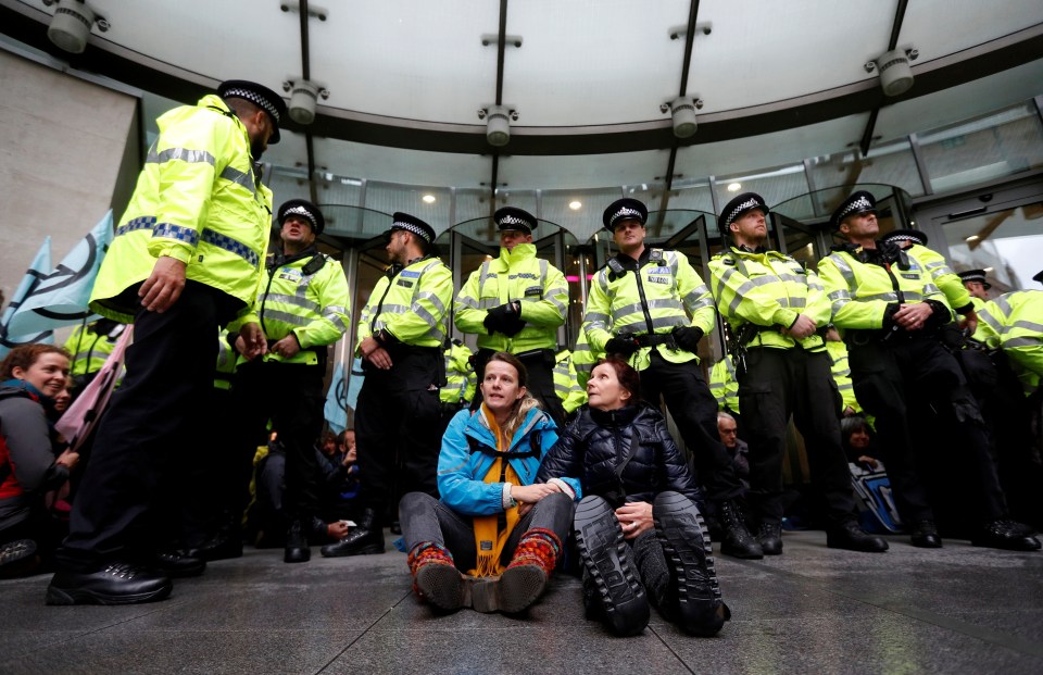  The group of around 40 sat on he floor as they were surrounded by cops