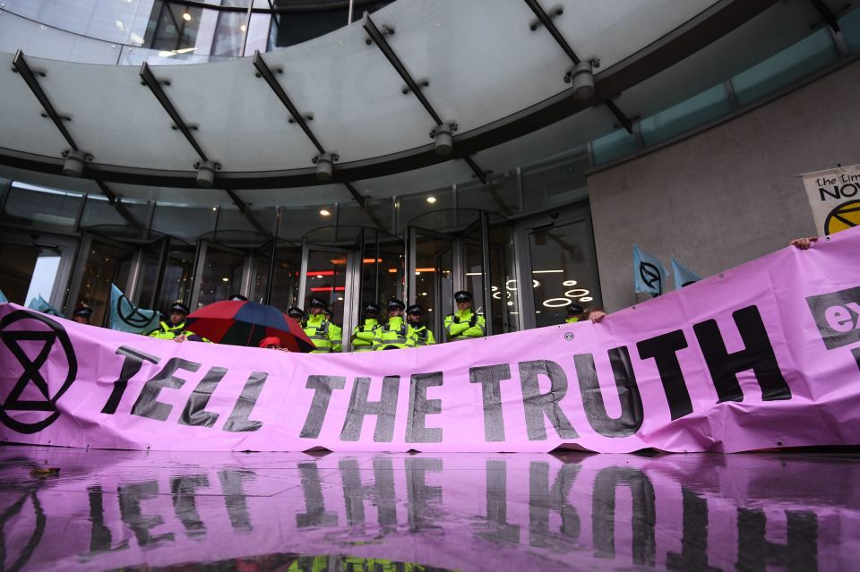  Protesters held a large banner saying 'tell the truth' outside the HQ