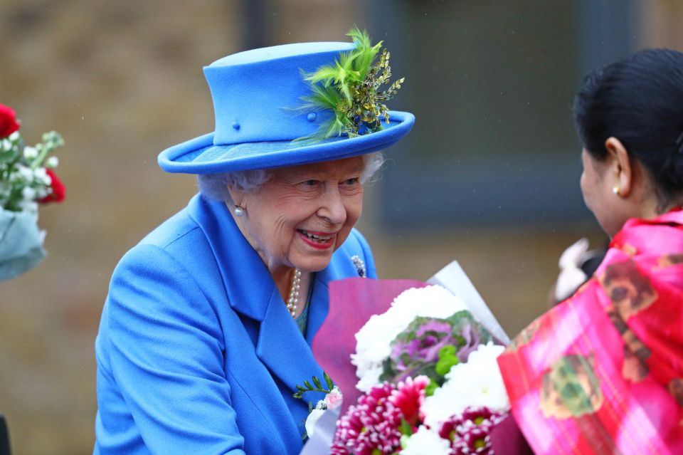  The Queen is given flowers as she arrives