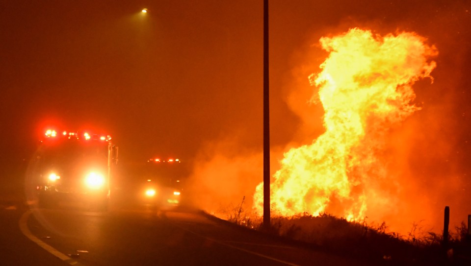 Los Angeles County firefighters battle a wind-driven wildfire in Sylmar