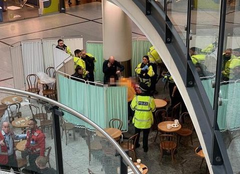  Emergency workers help a bloodied victim in Manchester's Arndale Centre