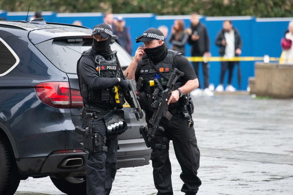  Armed cops gathered outside the shopping centre before storming in