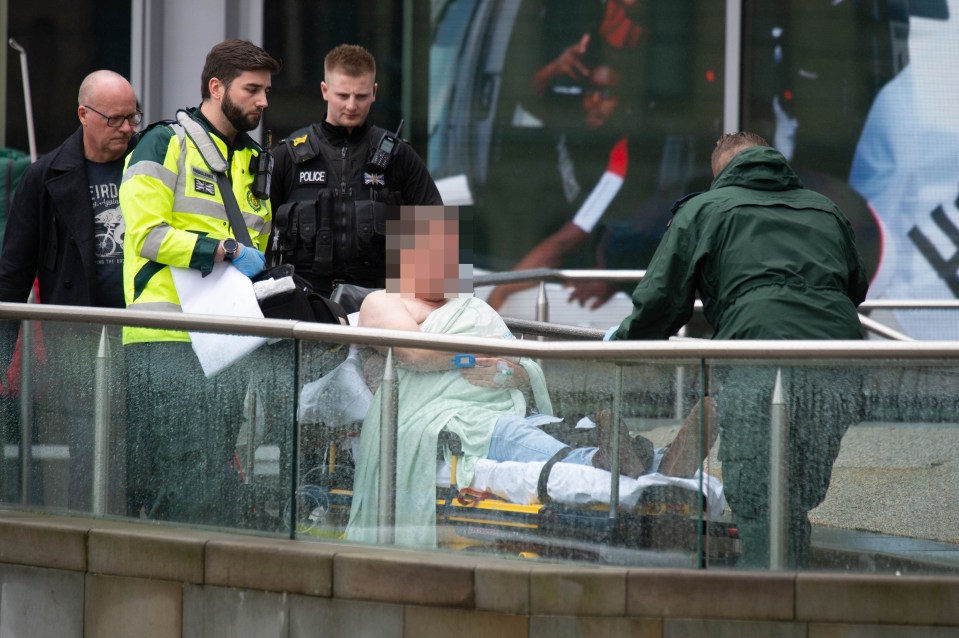  A victim is stretchered out of the shopping centre after the attack