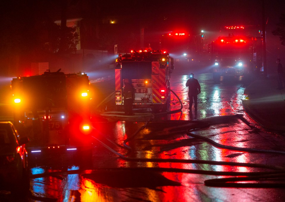 Firefighters work to save homes from the Saddleridge Fire in the Porter Ranch section of Los Angeles