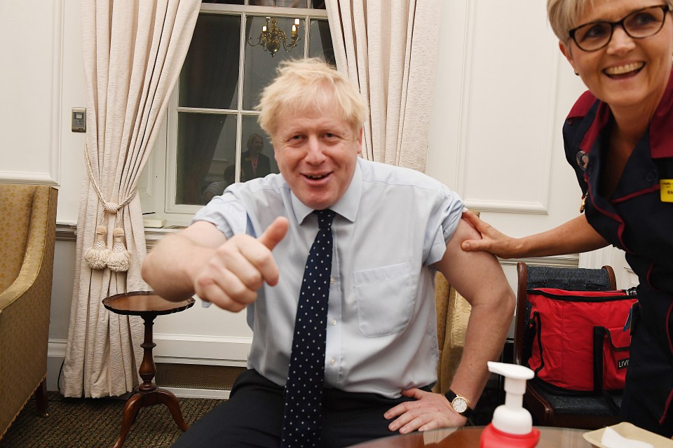  Boris Johnson smiles after getting his flu jab this morning