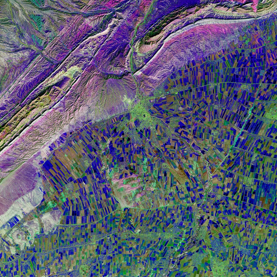  A bit of blue cubism in southern Uzbekistan highlights the intensive irrigation that is common along rivers that flow into the Aral Sea. However, so much water is used for irrigation that very little actually reaches the Aral Sea. The perplexing variety of blue and green shades are farm fields with actively growing vegetation among the scattered residential zones.