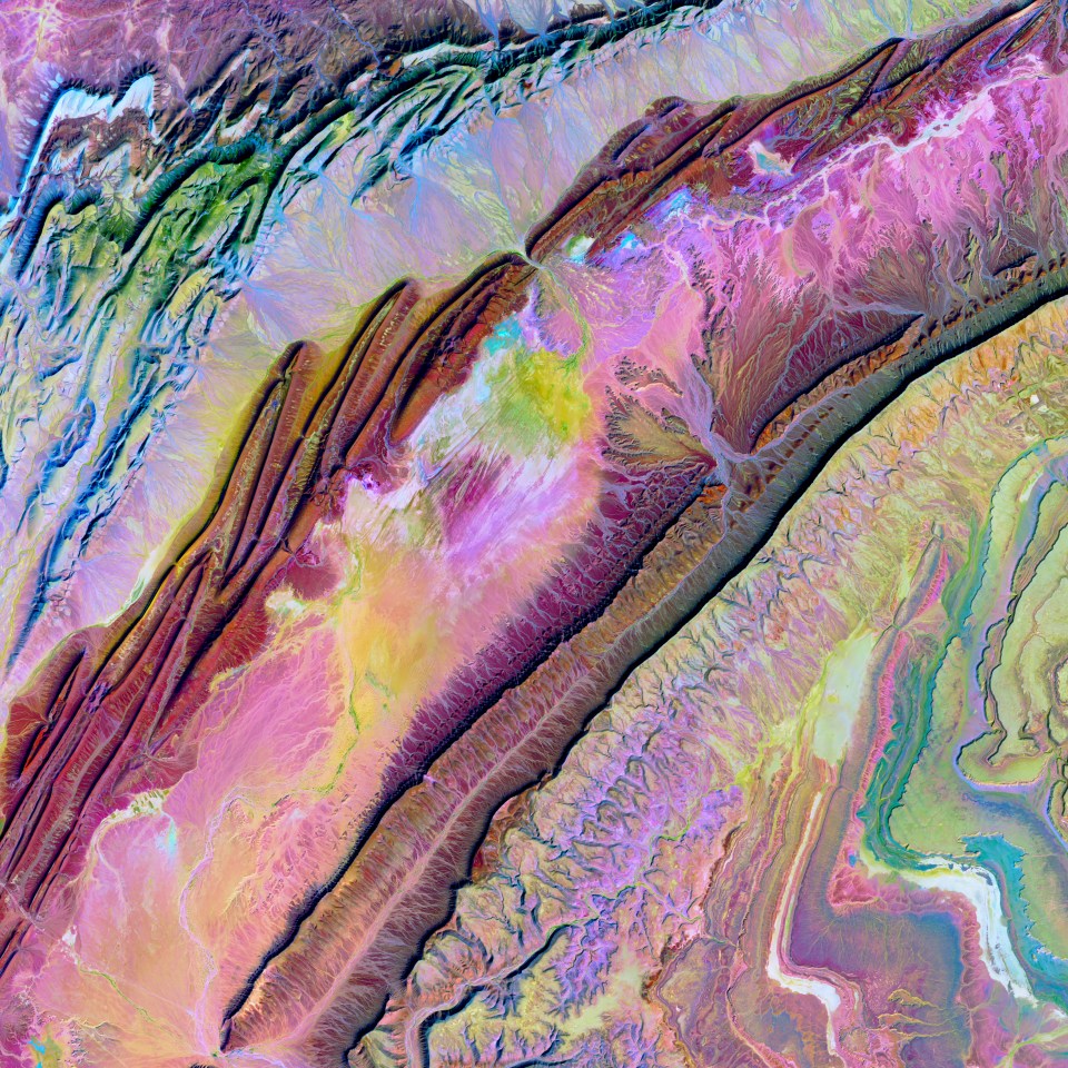  Rock folding on a tectonic scale occurred in northwestern Africa. These motley ribbons dancing across the desert in Morocco are folds caused by the prolonged collision of tectonic plates. The long continuous line is Jbel Ouarkziz, a ridge that rises 200–300m above the valley floors.