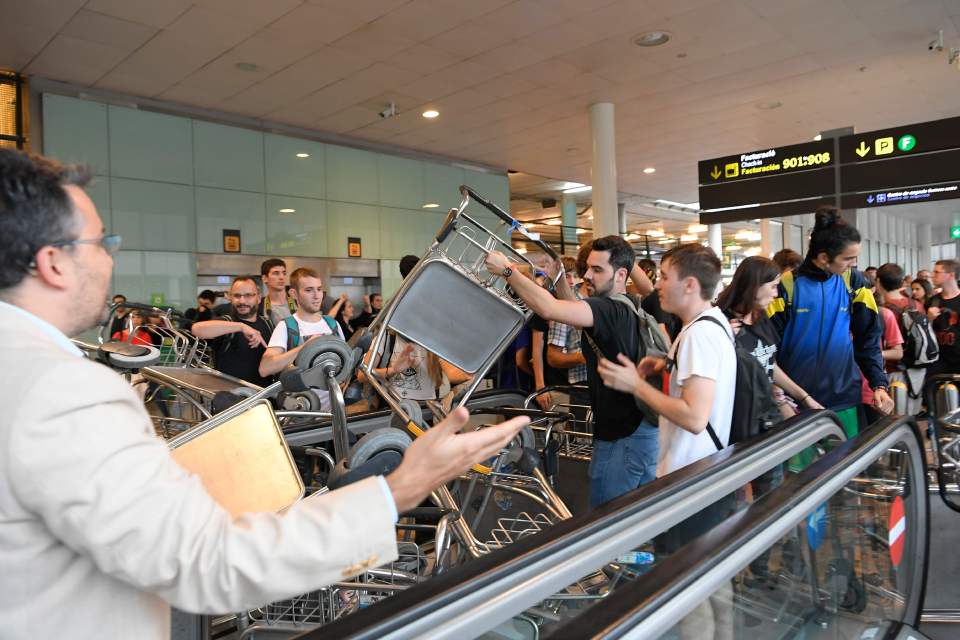  Pro-Independence protesters piled up airport luggage trolleys as thousands descended on the airport on Monday