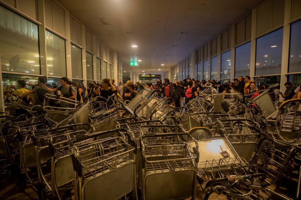  Luggage trolleys form a barricade at Barcelona airport