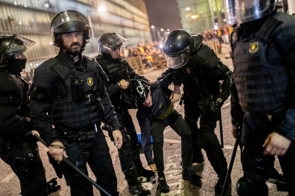  Riot police arrest a pro-Independence protester as violence erupted following the sentencing of 12 Catalan leaders yesterday