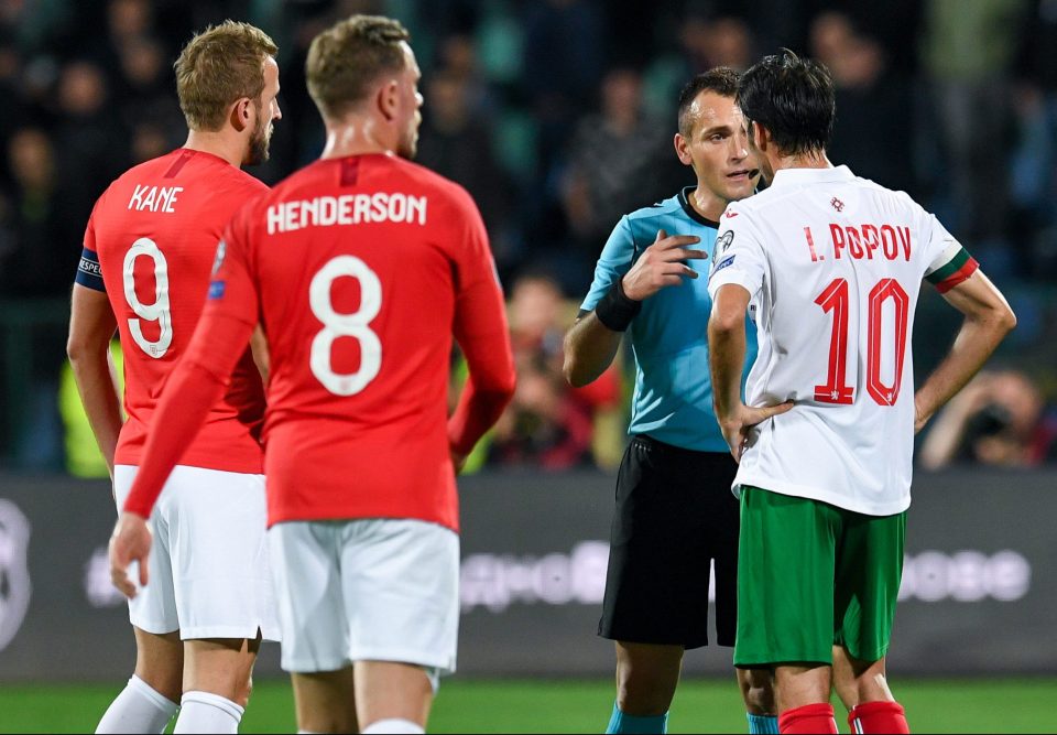  Ivelin Popov listens to referee Ivan Bebek after racial abuse from the terraces halted the game - before the striker told home fans to behave