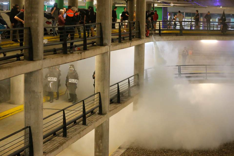  Tear gas fills part of the airport building as thousands of pro-Catalan protesters staged a demonstration