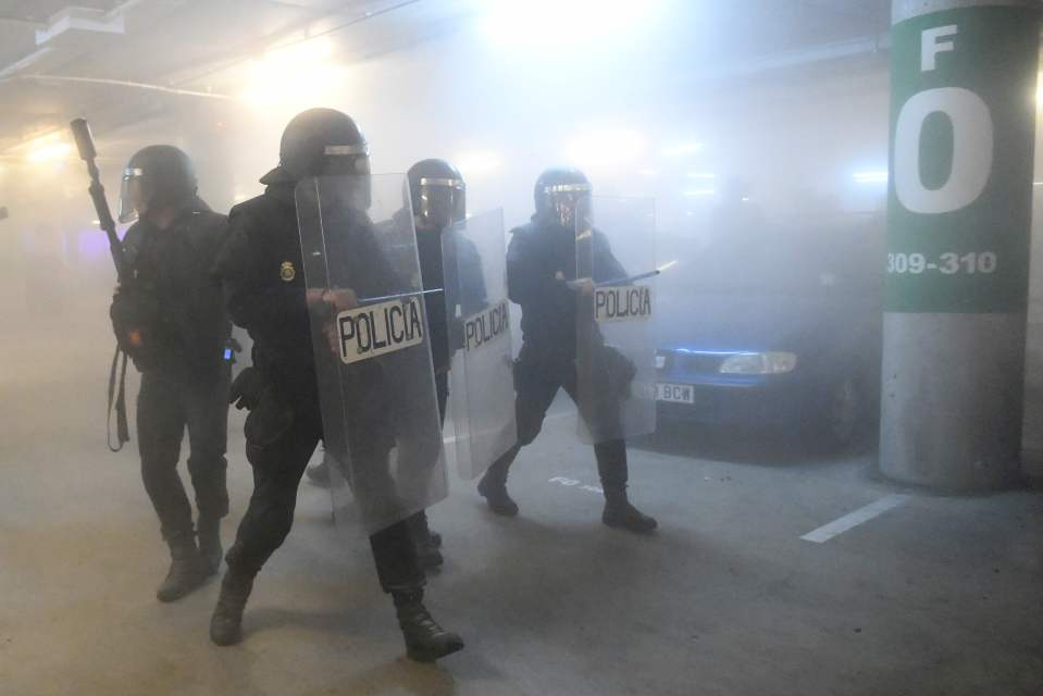  Riot cops patrol a car park at El Prat airport in Barcelona amid violent clashes with protesters