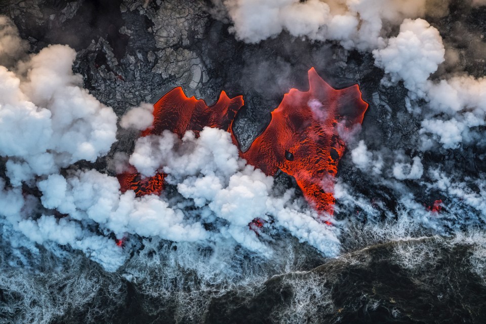  Creation by Luis Vilariño Lopez shows hot lava flowing into the Pacific Ocean on Hawaii’s Big Island