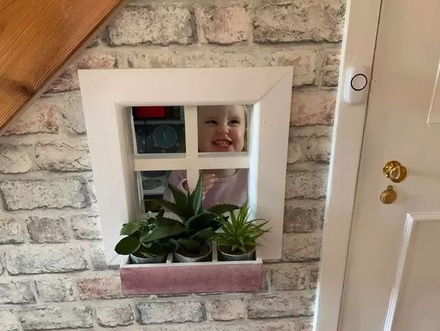  Karen added a flowerbox to the window and lined the outside of the 'house' with brick paper