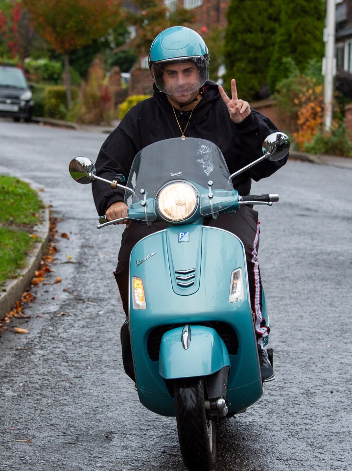  Arg later gave the peace sign as he was snapped riding round on his scooter